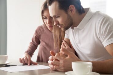 Couple looking at car warranty contract