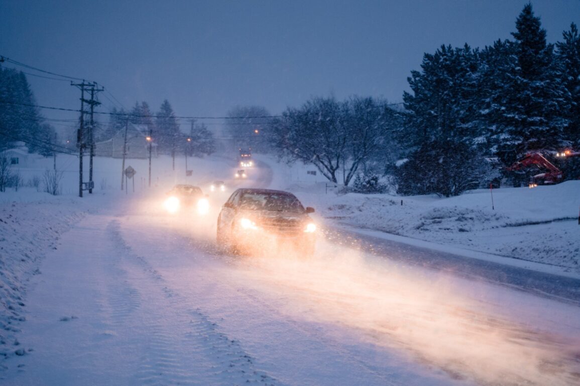 blizzard on the road during a cold winter evening P4QLUP3