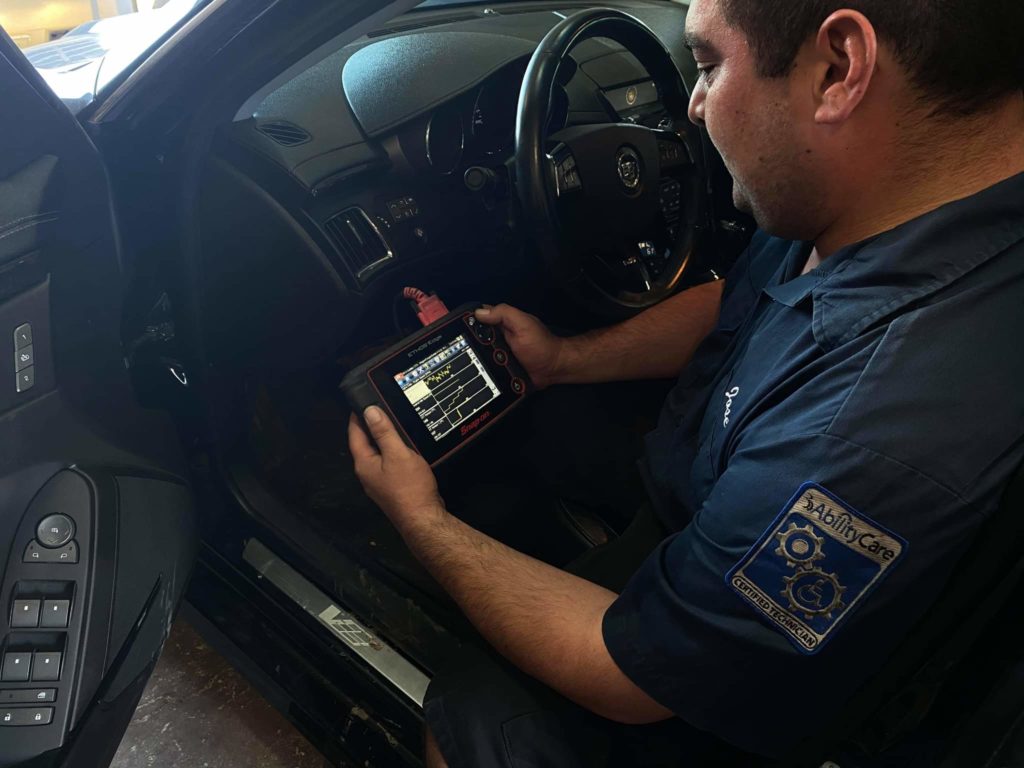 asTech In-Shop Technician Jose Campos reads PIDS/live data using an aftermarket scan tool. 