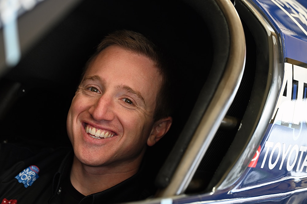 Justin Ashley, NHRA 2020 Rookie of the Year smiling sitting in his Top Fuel dragster