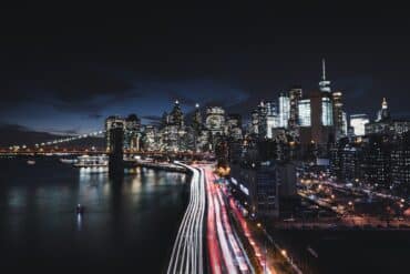 a nighttime long exposure photo of traffic in new york city with red and white lights